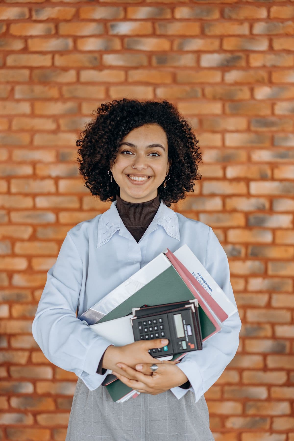 An advisor holding client files in the office