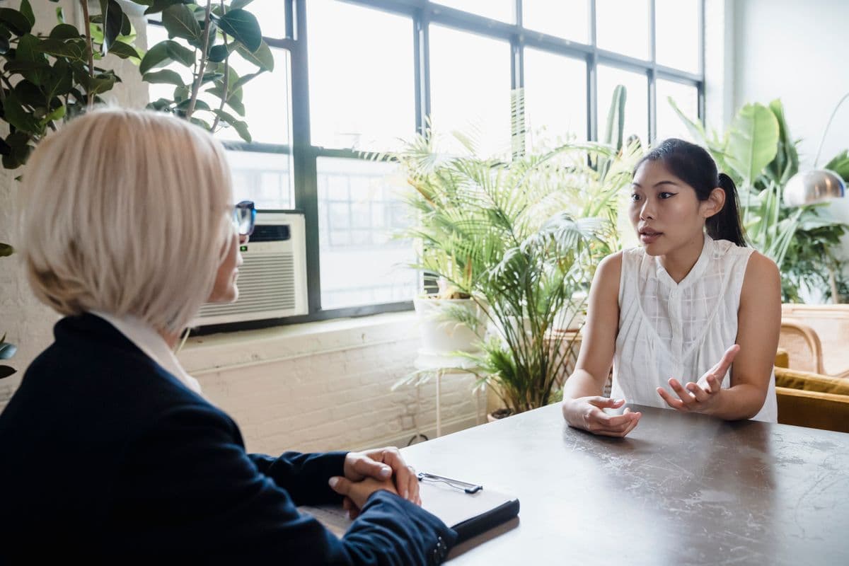 An advisor talking a client through their figures across a table