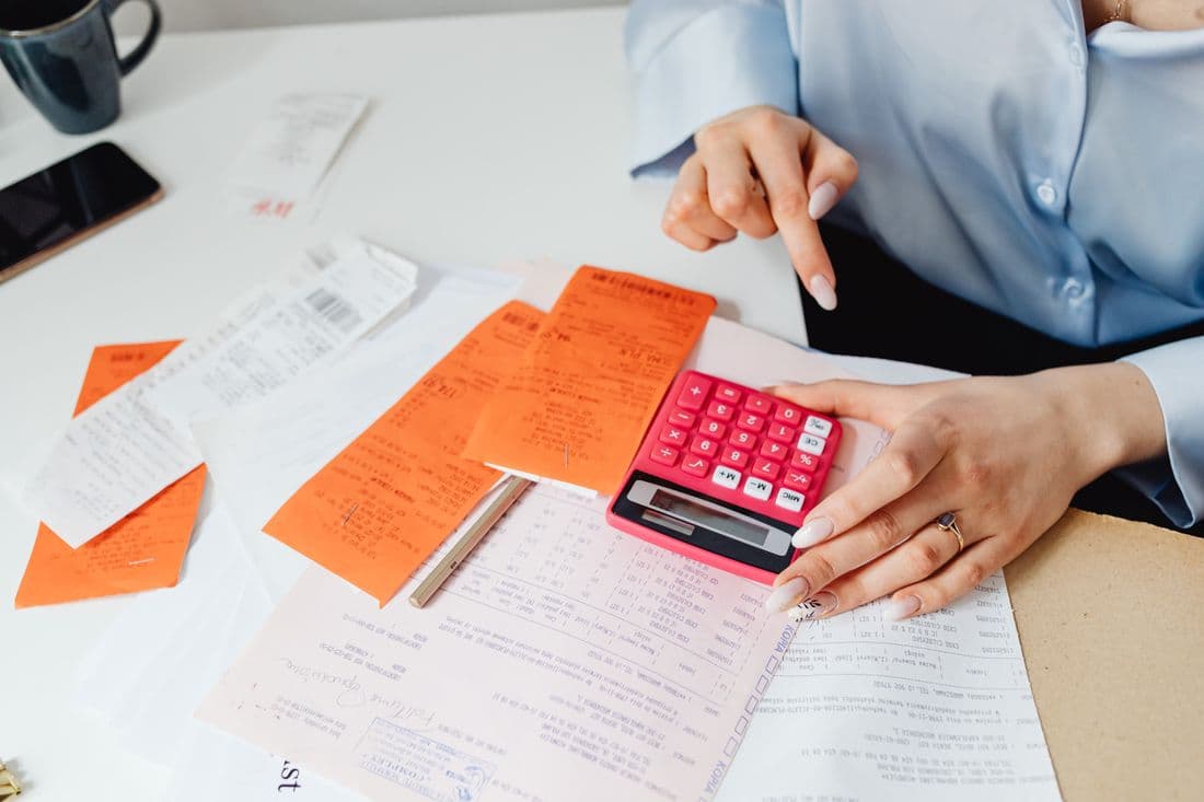 Receipts and a calculator being worked through at a desk