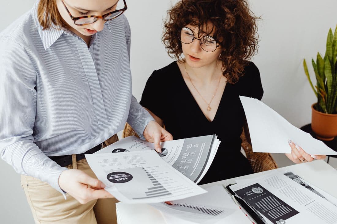 Two colleagues reviewing management accounts together