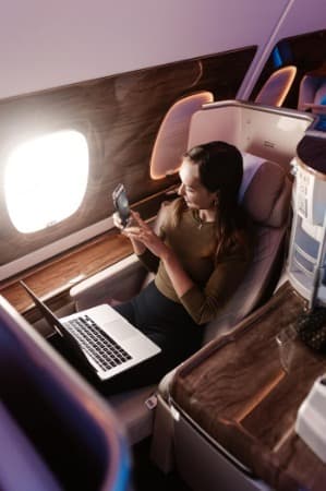 A founder working from her seat mid-flight