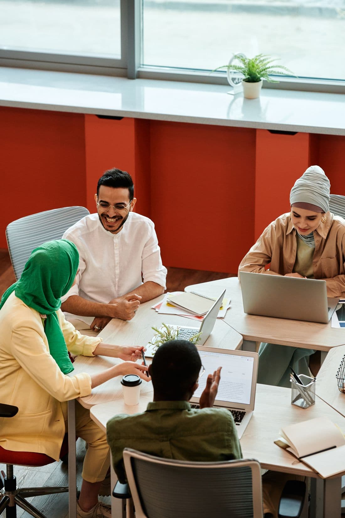 A team working together around a table in an open-plan office