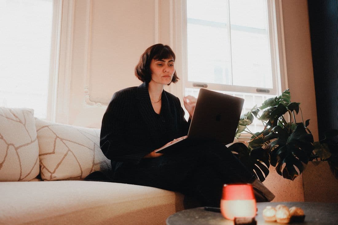 A founder working from a laptop in a bright apartment