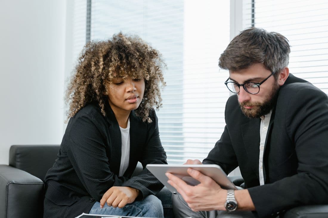 Two advisors reviewing a structure together on a tablet