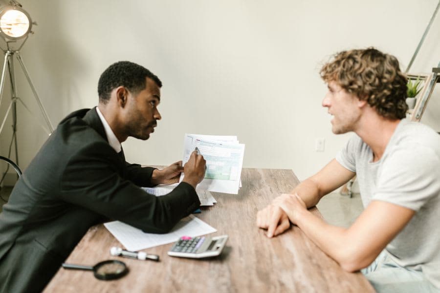 An accountant explaining a report to a client across a desk