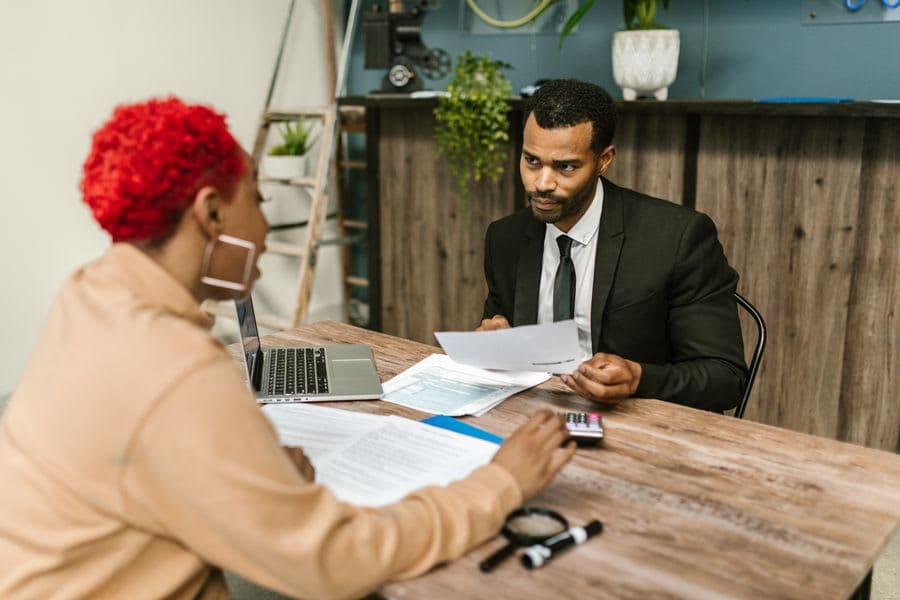 Two people reviewing statements together at a desk