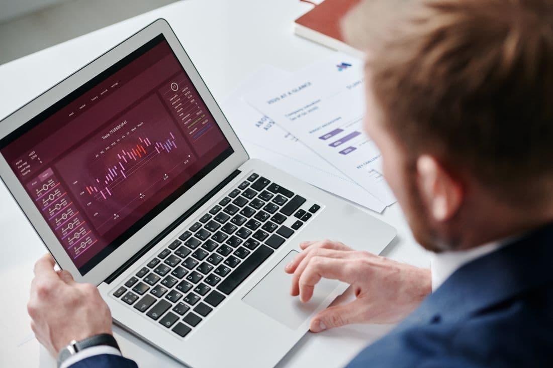 An executive reviewing a financial dashboard on a laptop