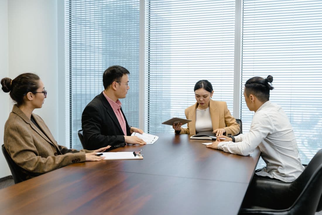 A leadership team working through the numbers in a boardroom