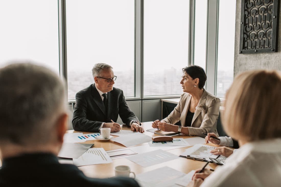 A leadership team setting strategy around a meeting table