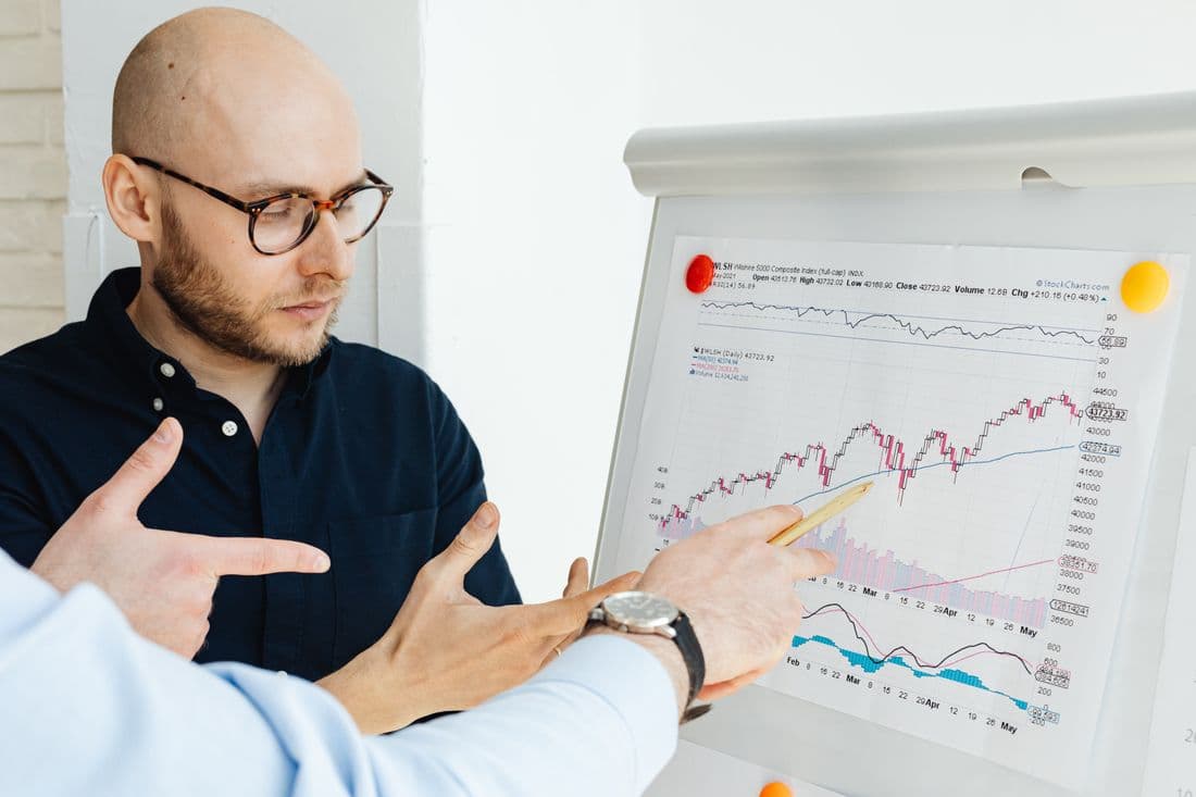 Colleagues working through a forecast on a flip chart