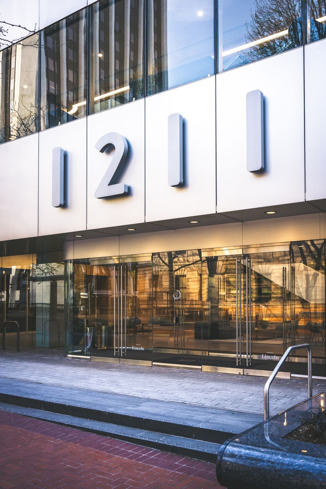 The glass entrance of a modern office building