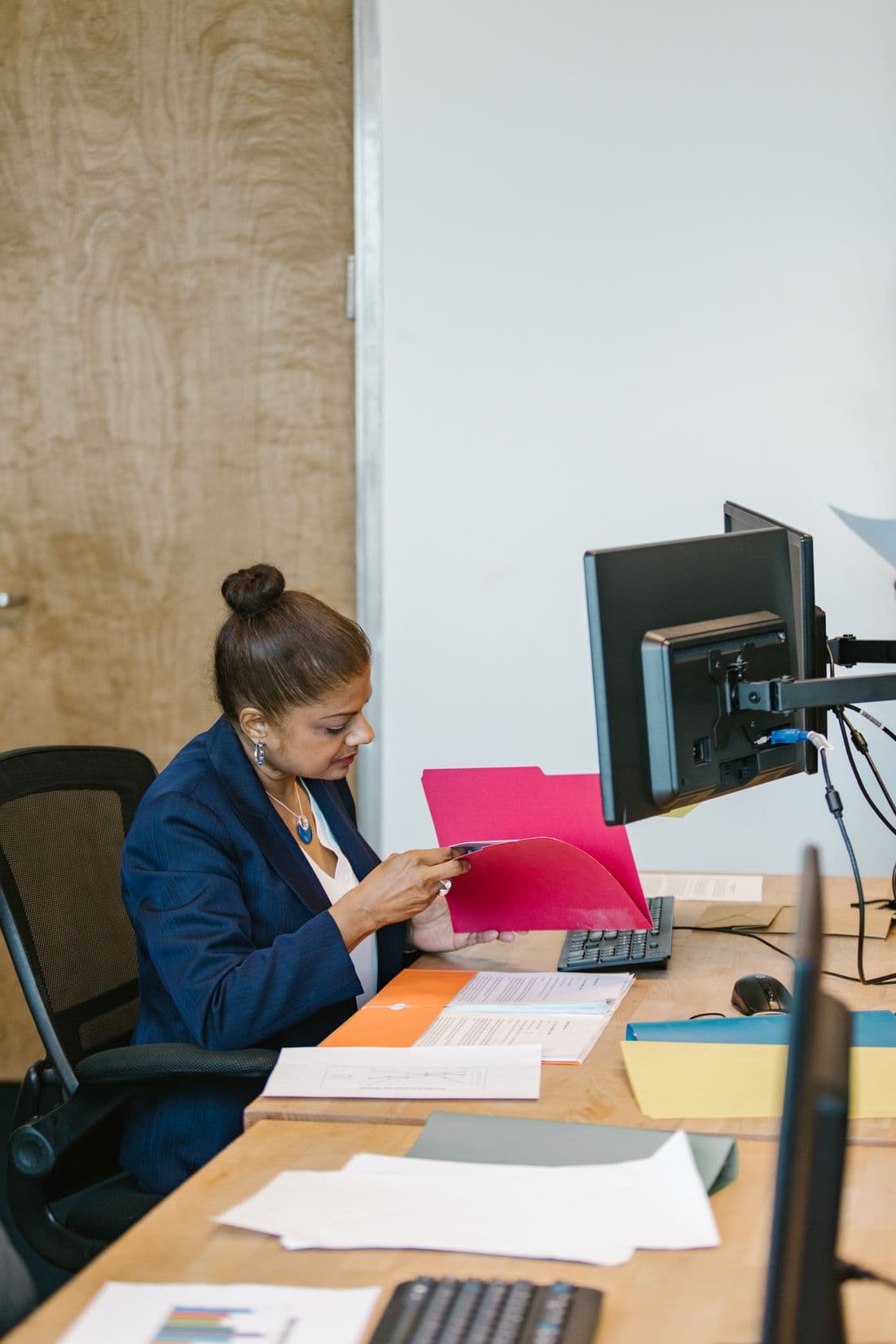 An adviser working through a client's files at their desk