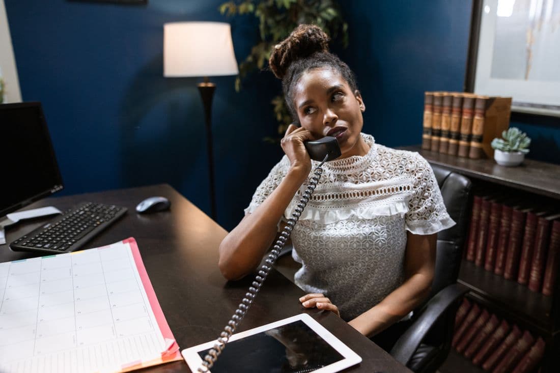 An adviser taking a client call at her desk
