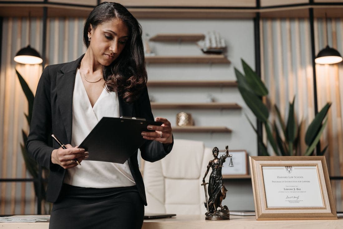 An adviser working through company paperwork at a desk