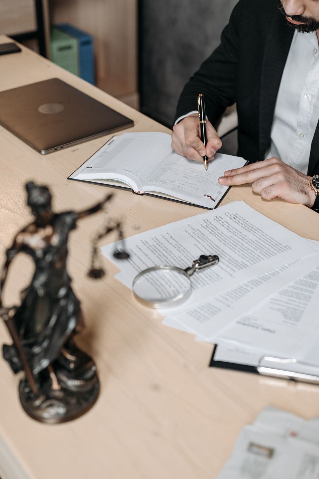 Statutory documents and a magnifying glass on a desk